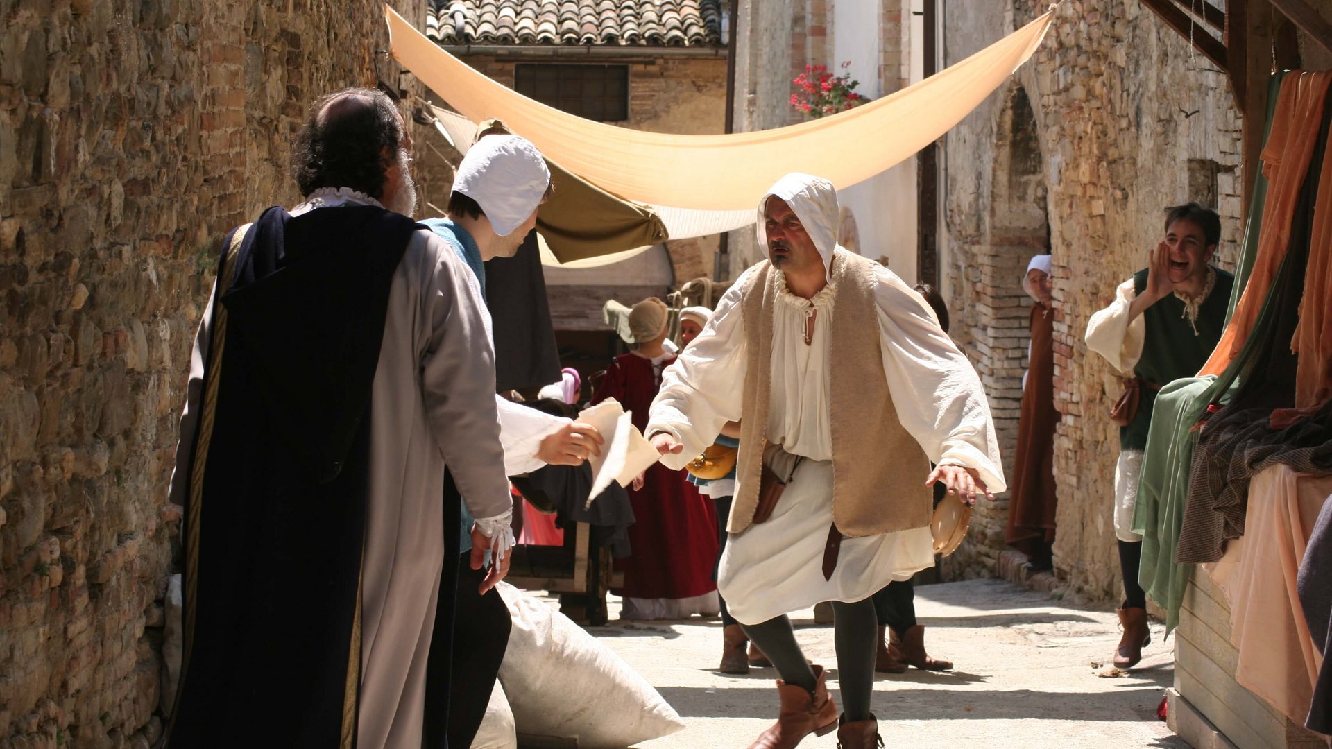 Basilica of Saint Francis of Assisi People in medieval costumes in a historic street during a reenactment
